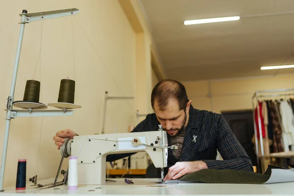 pattern, scissors, tape measure, and a sewing machine. Workplace