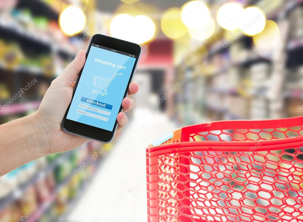 hand holding a modern smartphone in supermarket