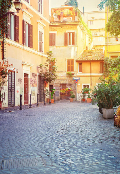 Typical italian street in Trastevere with sunshine, Rome, Italy