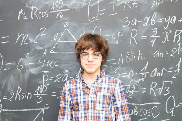 Pojke och blackboard fylld med matematiska formler — Stockfoto