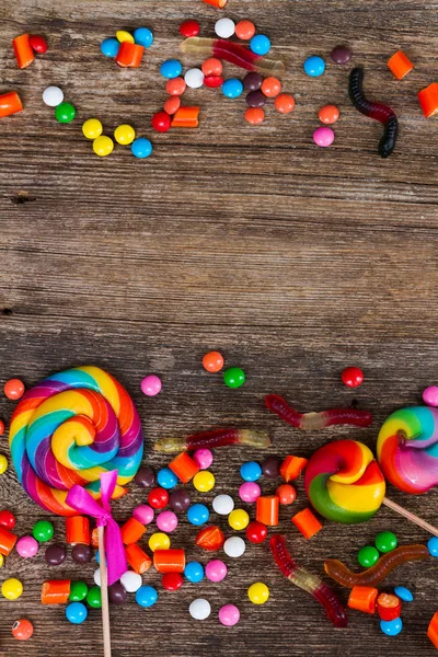 Colorful candies on wood — Stock Photo, Image
