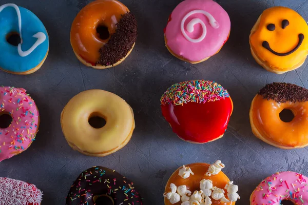 Sweet doughnuts on gray stone background — Stock Photo, Image