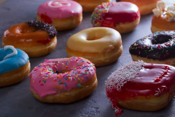Sweet doughnuts on gray stone background — Stock Photo, Image