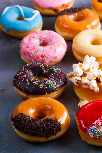 Sweet doughnuts on gray stone background — Stock Photo, Image