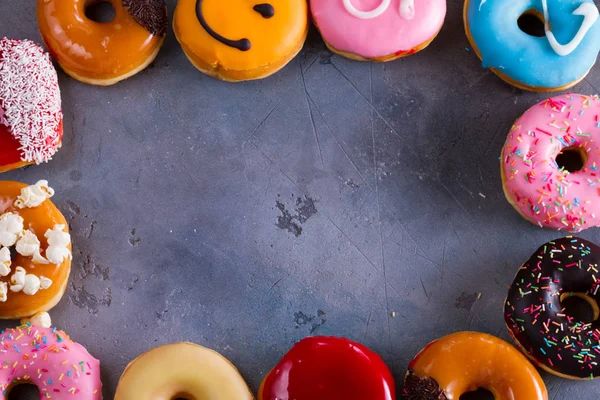 Sweet doughnuts on gray stone background — Stock Photo, Image