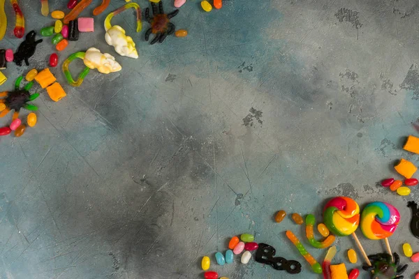 Colorful halloween candies on stone — Stock Photo, Image