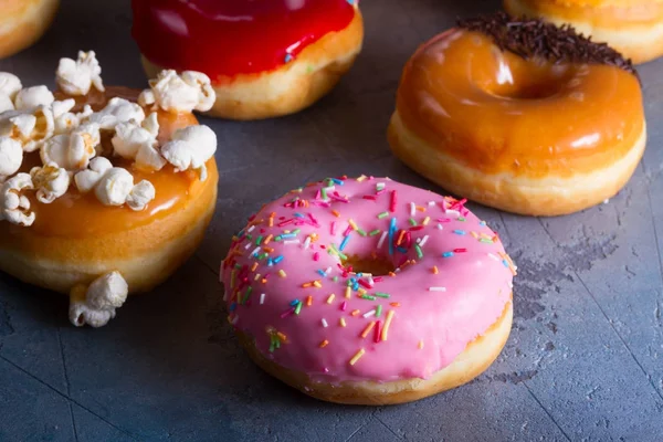 Sweet doughnuts on gray stone background — Stock Photo, Image