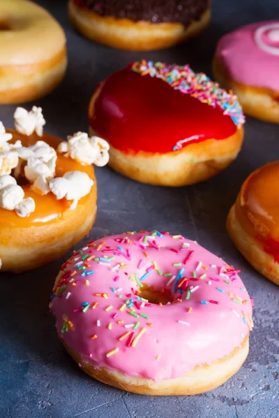 Sweet doughnuts on gray stone background — Stock Photo, Image