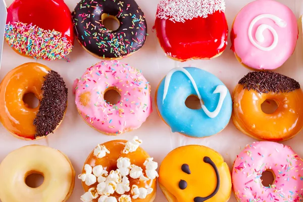 Sweet doughnuts on gray stone background — Stock Photo, Image