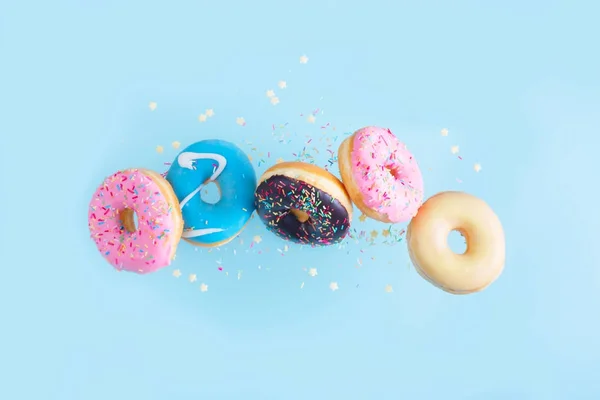 Flying doughnuts on blue — Stock Photo, Image