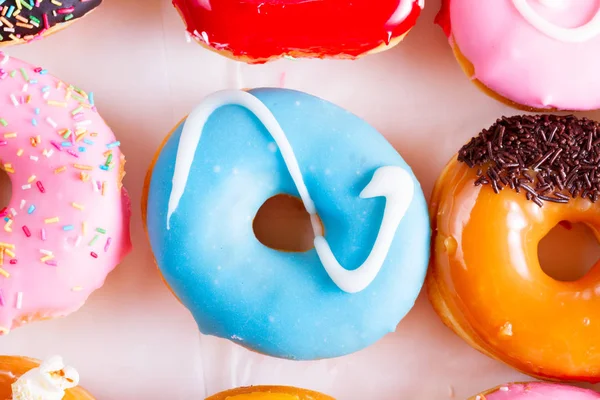 Sweet doughnuts on gray stone background — Stock Photo, Image