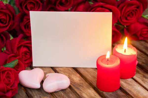 Two burning candles with fresh roses — Stock Photo, Image