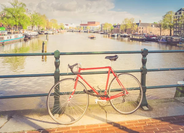 Gammal cykel intill kanalen i Amsterdam — Stockfoto