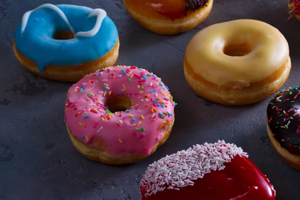 Sweet doughnuts on gray stone background — Stock Photo, Image