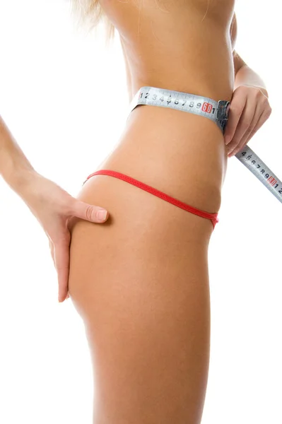 Mulher sexy medindo sua cintura com uma fita métrica — Fotografia de Stock