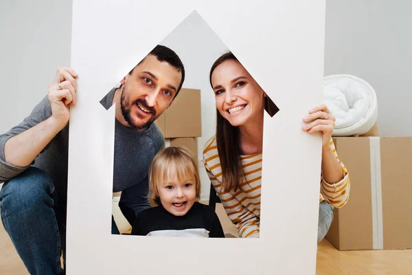 Family portrait, taken through house resembling frame