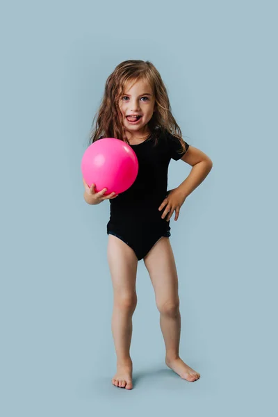 Little gymnast stands with pink ball for gymnastics. — Stock Photo, Image