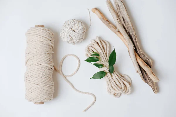 Cotton ropes and sticks from the river, grinded by water on a white surface — Stockfoto