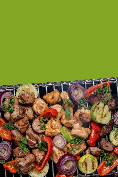 Close up of meat and vegetables coocking on grill over the coals on a barbecue — Stock Image Close up of meat and vegetables coocking on grill over the coals on a barbecue Royalty Free Stock Photos