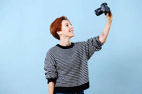 Cheerful middle aged woman with short ginger hair taking camera shot of herself. — Stock Photo, Image