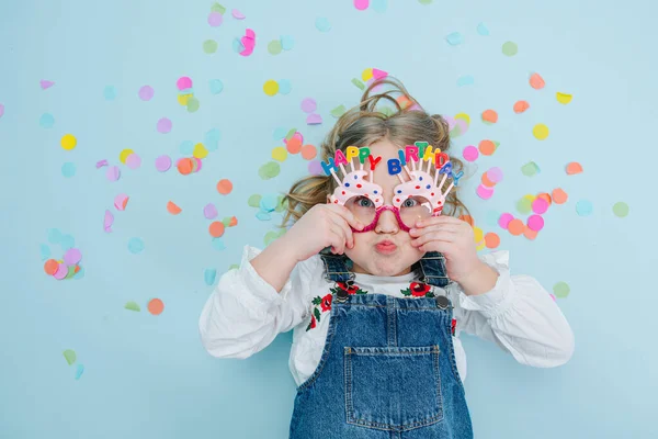 Happy Little Blonde Girl Happy Birthday Glasses Jeans Overalls Lies — Stock Photo, Image