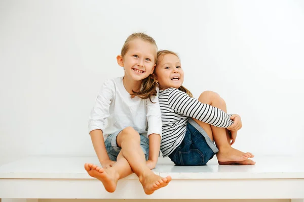 Happy Little Barefoot Siblings Sitting Table Legs White Wall Both — Stock Photo, Image