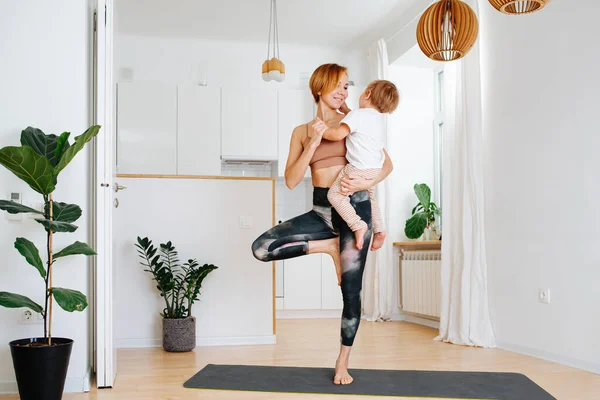 Mother Doing Yoga Mat Home While She Holding Her Little — Stock Photo, Image