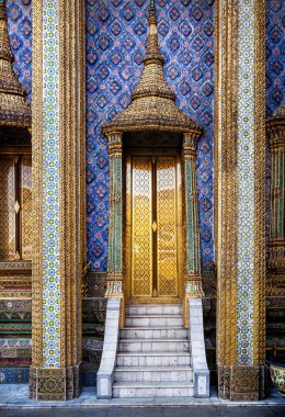 Golden doors of famous temple in Thailand clipart