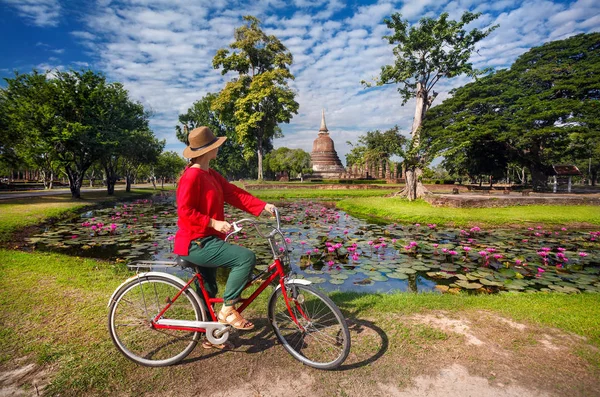 Mulher com bicicleta perto do templo na Tailândia — Fotografia de Stock