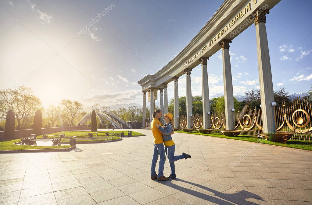 Happy couple hugging at the street