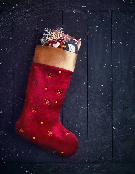 Red stocking with Christmas presents — Stock Photo, Image