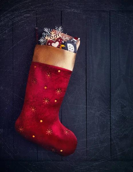 Red stocking with Christmas presents — Stock Photo, Image