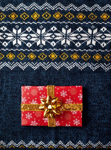 Red wrapped present on Christmas sweater — Stock Photo, Image