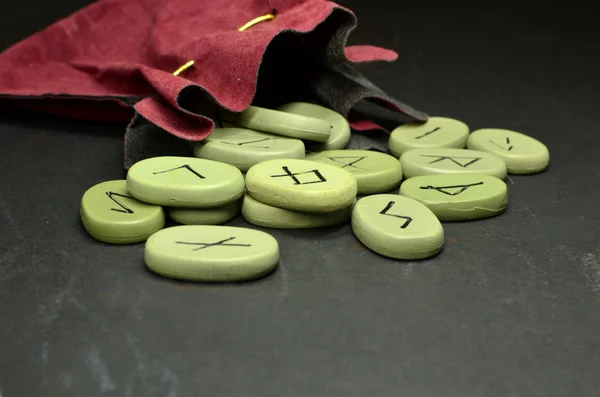 Runes on the black wooden Board and red velvet — Stock Photo, Image