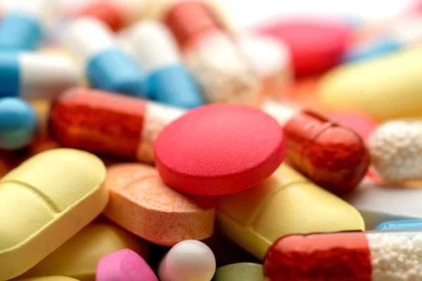 Multicolored pills on white background. — Stock Photo, Image