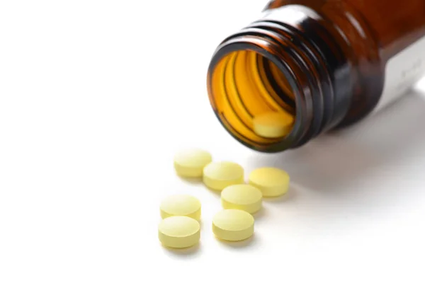 Pills with bottle on white background — Stock Photo, Image