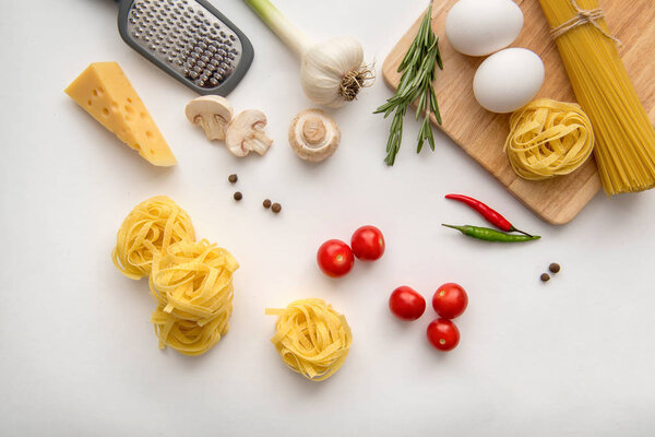 Ingredients for pasta cooking on white background