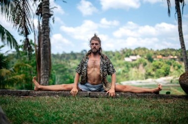 Erkek, dışarıda yoga ve meditasyon pratiği yapıyor.