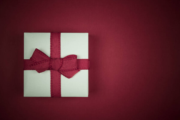 Little white gift isolated on red background