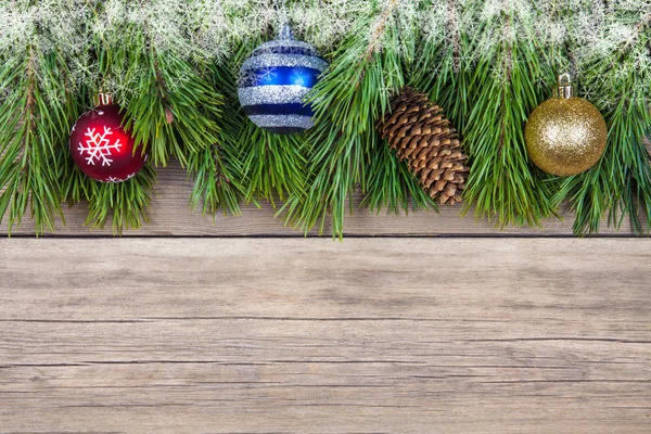 Christmas fir tree with toy on wooden background — Stock Photo, Image