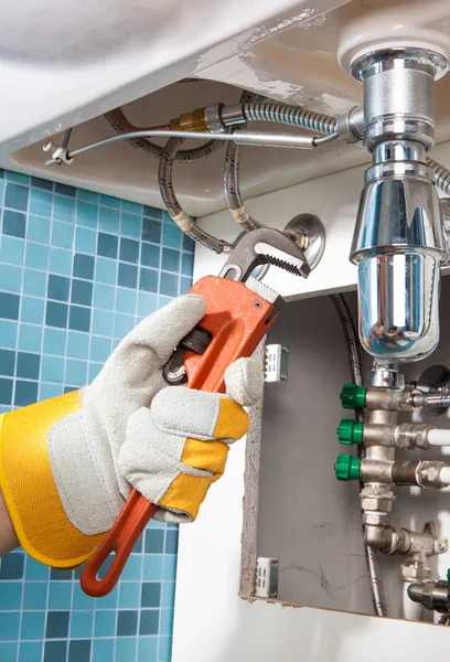 Repairing a pipe under sink. Plumber — Stock Photo, Image