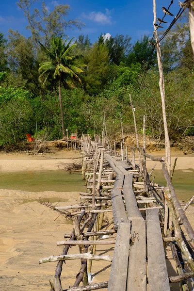 Abandoned old wooden bridge over the river Stock Photo