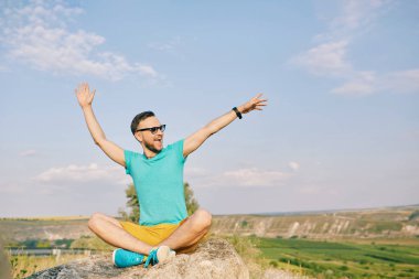 Gülümseyen ve güneşli yaz günü zevk genç adam