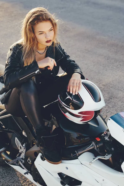 Chica motociclista en una ropa de cuero en una motocicleta —  Fotos de Stock