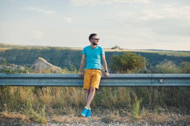 Gülümseyen ve güneşli yaz günü zevk genç adam