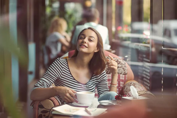 Jonge vrouw zitten binnen in stedelijke café — Stockfoto