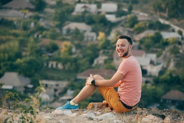 Gülümseyen ve güneşli yaz günü zevk genç adam