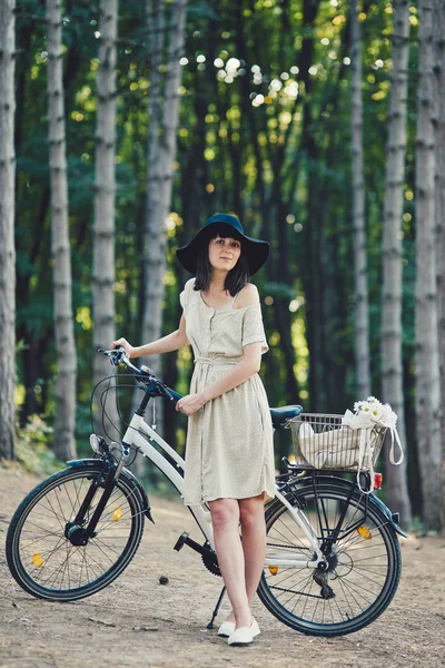 Young woman against nature background with bike — Stock Photo, Image