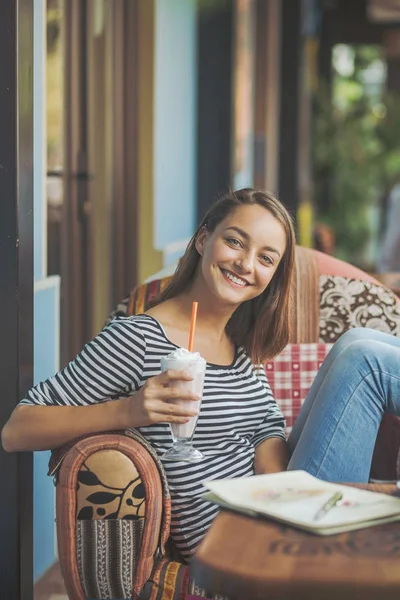 Jonge vrouw zitten binnen in stedelijke café — Stockfoto