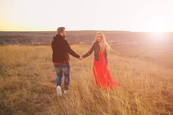 Couple in love walking through grass — Stock Photo, Image